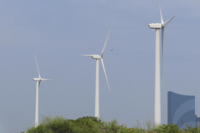 Land-based wind turbines spin in Atlantic City N.J. on July 20, 2023. Wind developer Orsted scrapped plans for two large offshore projects in New Jersey this week, citing supply chain problems and high interest rates.