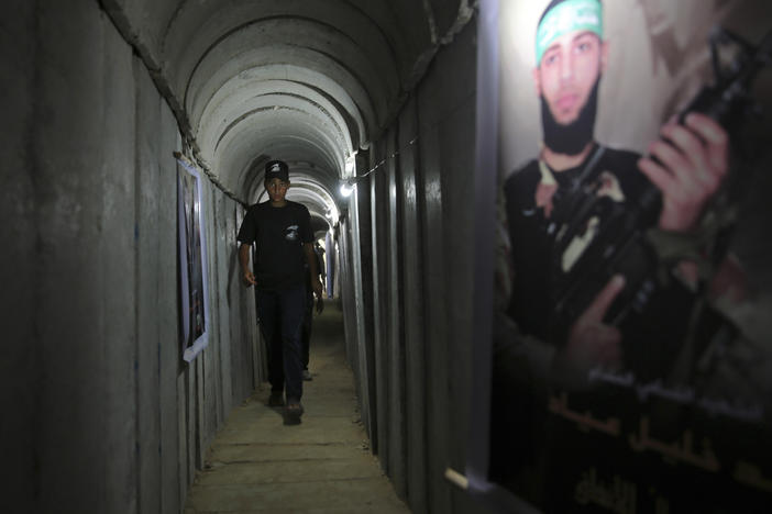 A Palestinian youth walks inside a tunnel used for military exercises during a Hamas-run camp in 2016. Hamas says it has built 300 miles of tunnels under Gaza.