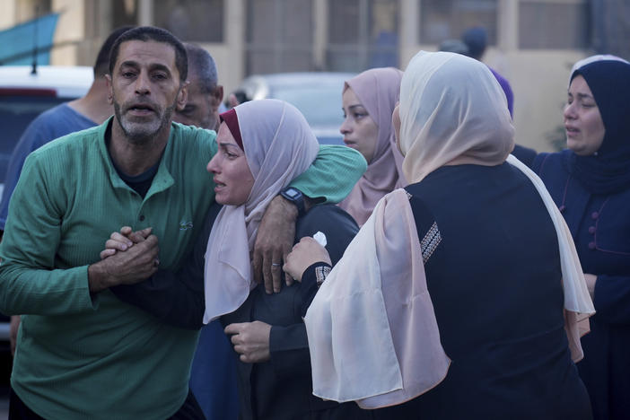 Palestinians mourn relatives killed in the Israeli bombardment of the Gaza Strip in front of the morgue in Deir al-Balah on Monday.