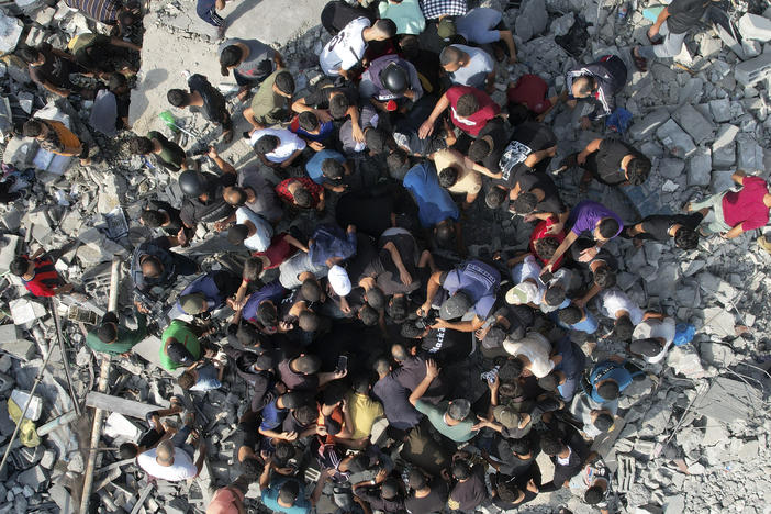 Palestinians look for survivors of an Israeli bombardment in the Maghazi refugee camp in the Gaza Strip on Sunday.