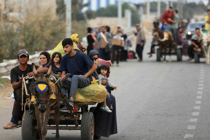 Palestinians arrive south of Gaza City on Sunday after fleeing their homes amid the ongoing battles between Israel and Hamas.