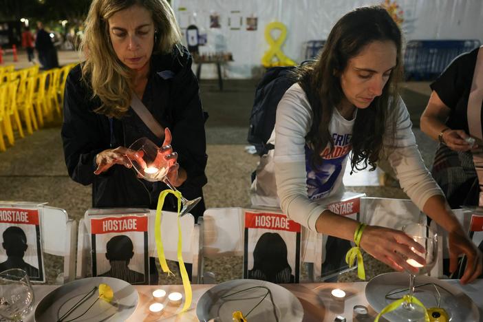 Women prepare a symbolic dinner table during a rally in Tel Aviv, Israel, on Tuesday, demanding the release of Israelis held hostage in the Gaza Strip since the Oct. 7 attack by Hamas militants.