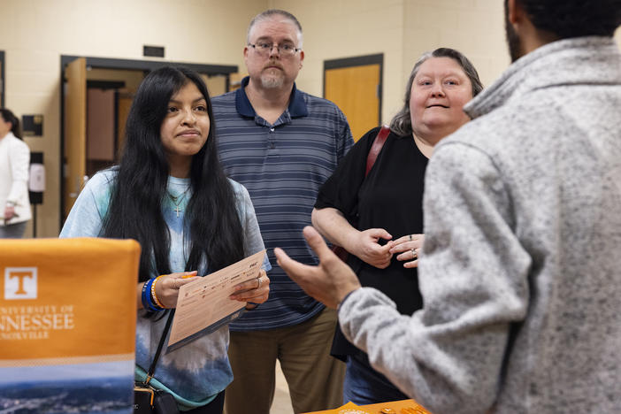 Marla McCreless, a junior at Cookeville High School, and her parents, Mark and Chastity McCreless, talk to University of Tennessee recruiter Dakota Hodges.