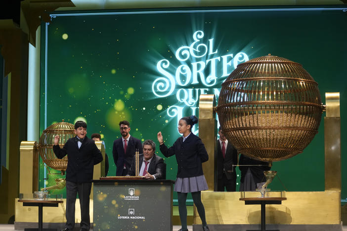 Children from Madrid's San Ildefonso school sing out the numbers from one of the main prizes from awarded lottery balls in Madrid, Spain, Friday, Dec. 22, 2023.