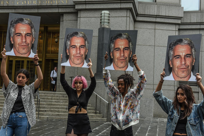A protest group called "Hot Mess" holds up signs of Jeffrey Epstein on July 8, 2019 in New York City.