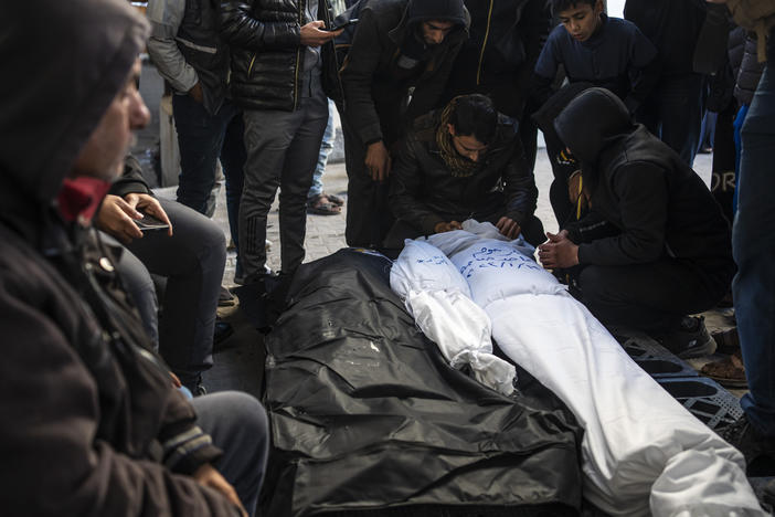 Palestinians mourn relatives killed in the Israeli bombardment of the Gaza Strip in Rafah, Saturday, Jan. 13, 2024.