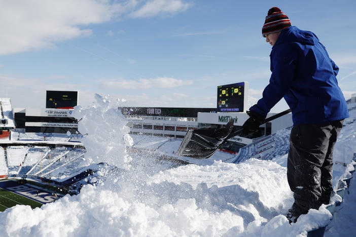 Brady Reinagel shovels snow before the AFC Wild Card playoff game between the Buffalo Bills and Pittsburgh Steelers at Highmark Stadium in Buffalo, N.Y. The Bills hired local residents to help clear snow from the stadium before Monday's game.