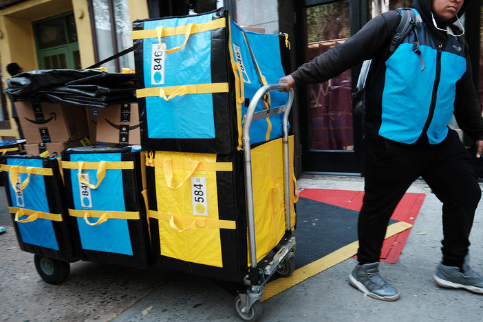 An Amazon worker in New York moves boxes on Amazon Prime Day (Photo by Spencer Platt/Getty Images)