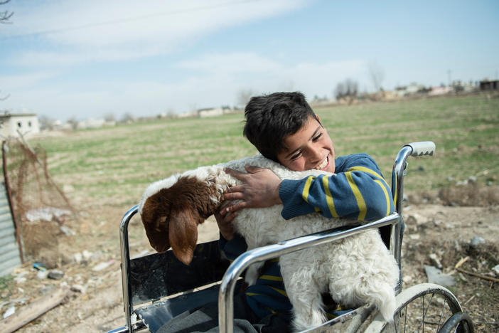 Azzam, 12, hugs a sheep, the only source of his family's livelihood in rural Damascus on Feb 21, 2022. Azzam and his family have experienced firsthand the harrowing impact of the conflict. In 2015, when Azzam was five years old, a shell fell on the building where he was sitting with his family.