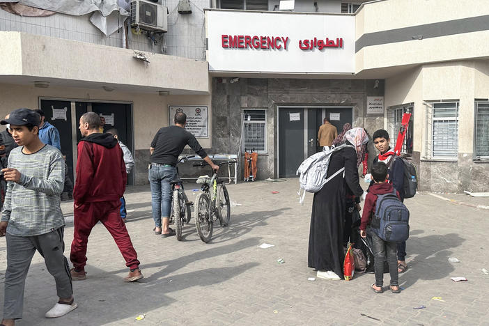 Displaced Palestinians gather in the yard of Gaza's Al-Shifa hospital on Dec. 10, 2023. The hospital, Gaza's largest, was raided by the Israeli military early on Monday.