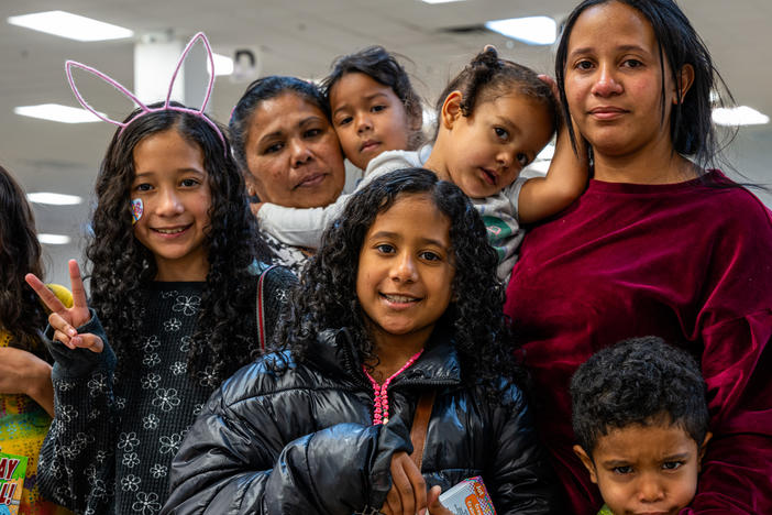 Yajaíra Peñaloza (left) and Marian Araujo pose with their children while waiting for their ride at the Casa Alitas shelter in Tucson, Ariz., on March 26.