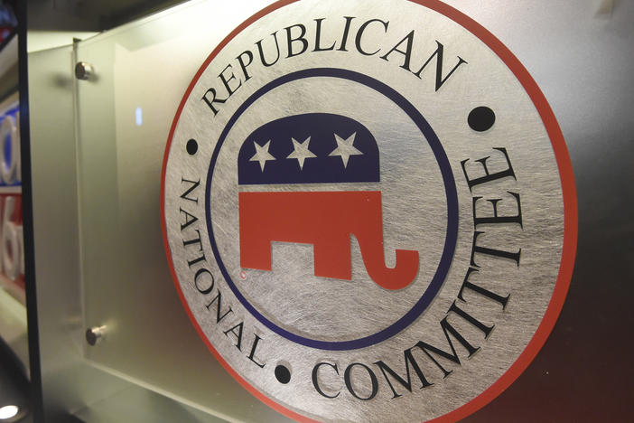 The Republican National Committee logo is shown on the stage as crew members work at the North Charleston Coliseum, Jan. 13, 2016, in North Charleston, S.C.