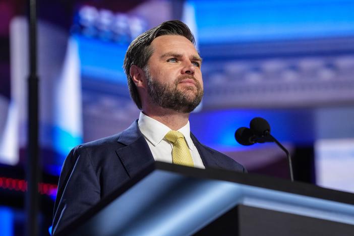 J.D. Vance, Trump's vice presidential running mate, stands at a podium during a walkthrough for the 2024 Republican National Convention in Milwaukee.