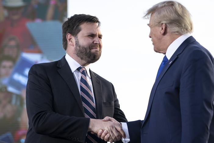 Sen. J.D. Vance of Ohio shakes hands with former President Donald Trump during a rally in Delaware, Ohio in 2023. Vance has ties to tech billionaires who are endorsing his vice presidential nomination.