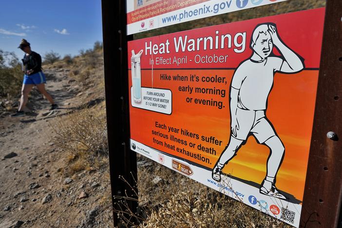 A hiker finishes her hike early to beat high temperatures on July 10, 2023, in Phoenix.