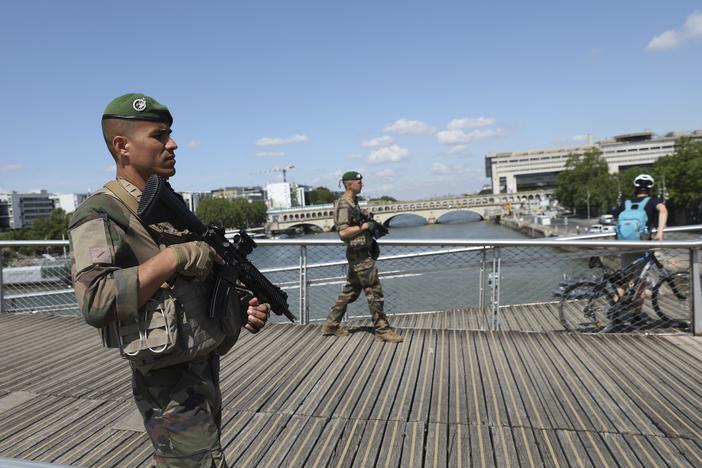 Soldiers patrol on a footbridge over the Seine River on Wednesday in Paris.