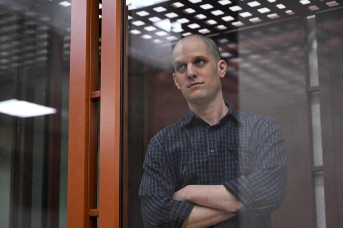 Evan Gershkovich, accused of espionage, looks out from inside a glass defendants' cage prior to a hearing in Yekaterinburg's Sverdlovsk Regional Court on June 26.