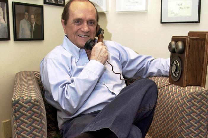 Comedian Bob Newhart pretends to speak on an antique telephone at his home in the Bel Air Estates community of Los Angeles, June 25, 2003. 
