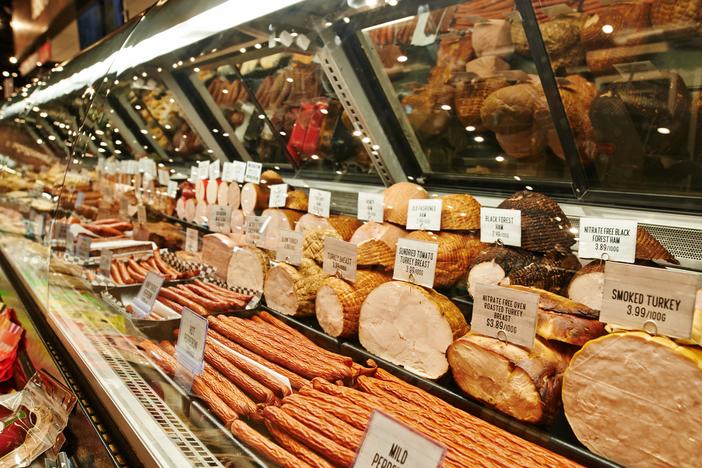 At least two people have died and more than a dozen have been hospitalized in connection with a listeria outbreak linked to meat sold at deli counters, the Centers for Disease Control and Prevention said.