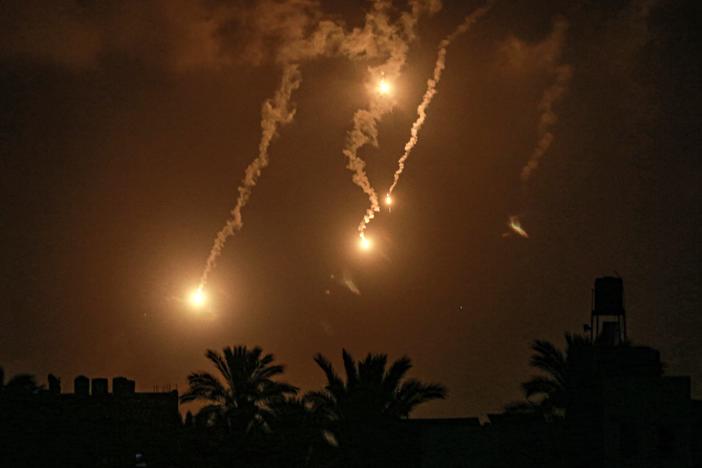 Flares fired by the Israeli military north of Nuseirat are pictured from Deir el-Balah in the central Gaza Strip late on July 1.