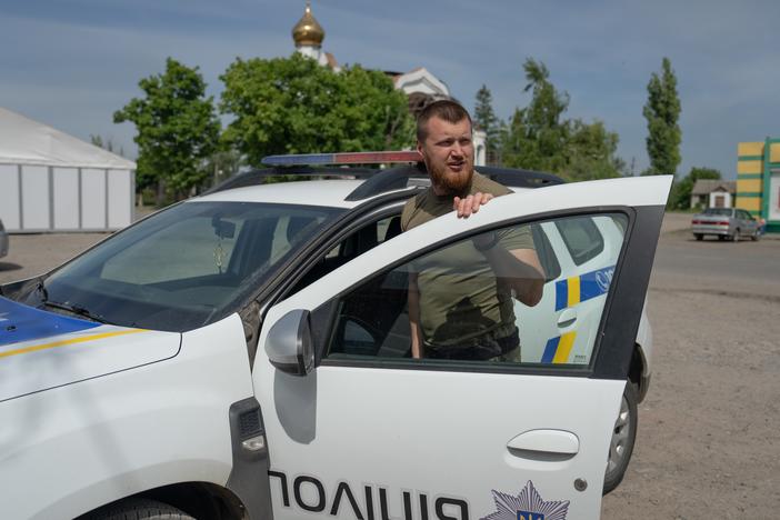 Oleksii Kharkivskyi, the chief of the patrol police of Vovchansk, in his police car in an undisclosed location in Kharkiv Oblast, Ukraine, on May 26.