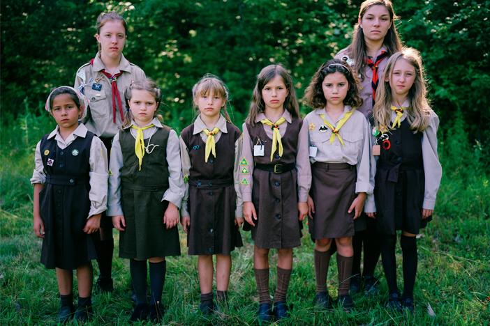 A group of <em>novachky</em>, female campers ages 6-11, stand at attention for a photograph, along with their two <em>sestrichky</em>, or "sisters" who serve as female counselors. Marching drills are a daily activity at camp.
