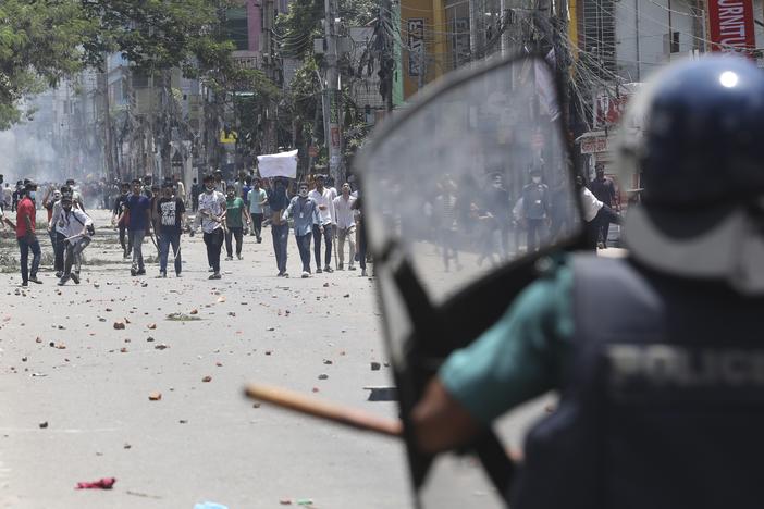 Students clash with riot police during a protest against a quota system for government jobs, in Dhaka, Bangladesh, Thursday, July 18, 2024.