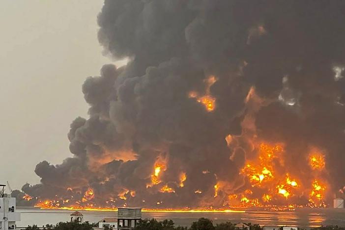 A handout picture obtained from Yemen's Huthi Ansarullah Media Center show a huge column of fire erupting following reported strikes by Israeli fighter jets in the Yemeni rebel-held port city of Hodeidah on Saturday. 