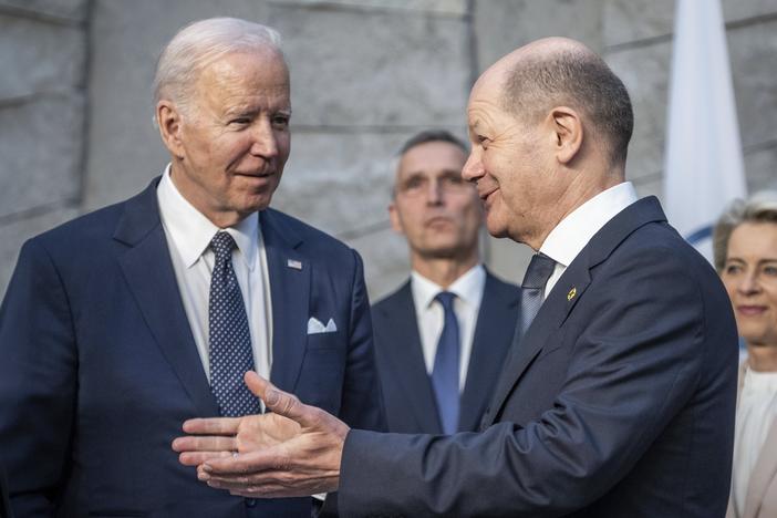U.S. President Joe Biden, left, and German Chancellor Olaf Scholz talk during a NATO summit at NATO headquarters in Brussels, Belgium, in March 2022.
