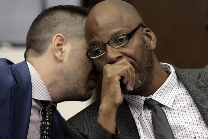 FILE - Christopher Dunn, right, listens to his attorney Justin Bonus from New York City during the first day of his hearing to decide whether to vacate his murder conviction, Tuesday, May 21, 2024, at the Carnahan Courthouse in St. Louis. A Missouri judge on Monday, July 24, 2024, overturned the conviction of Dunn, who has spent more than 30 years in prison for a killing he has long contended he didn’t commit. 