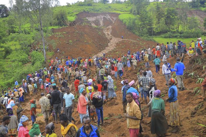 Hundreds of people gather at the site of a mudslide in the Kencho Shacha Gozdi district, Gofa Zone, southern Ethiopia, on Monday. At least 157 people were killed in mudslides in a remote part of Ethiopia that has been hit with heavy rainfall, according to local authorities.