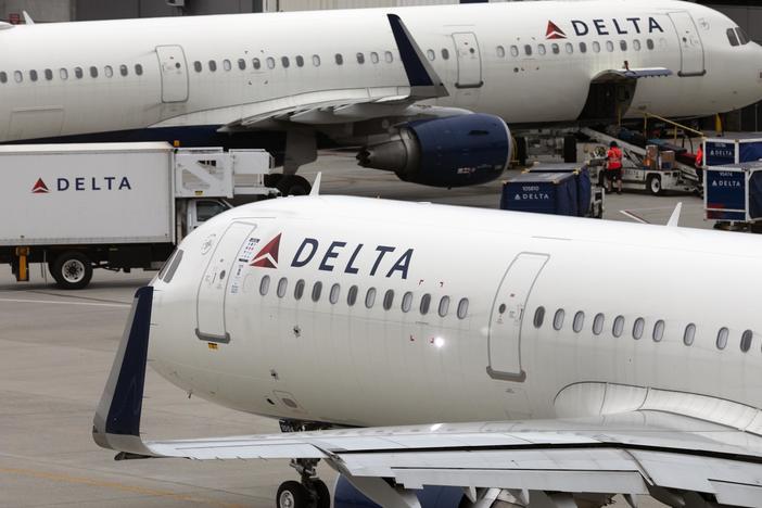 U.S. airline regulators have opened an investigation into Delta Air Lines, which was still struggling to restore operations on Tuesday, more than four full days after a faulty software update caused technological havoc worldwide and disrupted global air travel. Here, a Delta Air Lines plane leaves the gate on July 12, 2021, at Logan International Airport in Boston.
