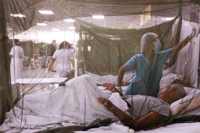 A nurse takes care of a dengue fever patient at the Sergio Bernales National Hospital in the outskirts of Lima on April 17. The number of suspected cases in Peru so far this year is over 100,000.