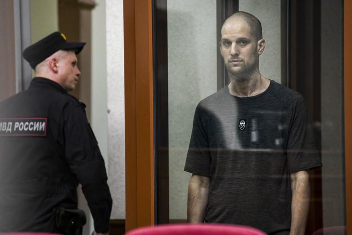 <em>Wall Street Journal</em> reporter Evan Gershkovich stands in a glass cage of a Russian courtroom on  July 19. A Russian court convicted Gershkovich on espionage charges that his employer and the U.S. have rejected as fabricated. He was sentenced to 16 years in prison after a secretive and rapid trial. 