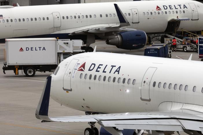 U.S. airline regulators have opened an investigation into Delta Air Lines, which was still struggling to restore operations on Tuesday, more than four full days after a faulty software update caused technological havoc worldwide and disrupted global air travel. Here, a Delta Air Lines plane leaves the gate on July 12, 2021, at Logan International Airport in Boston.