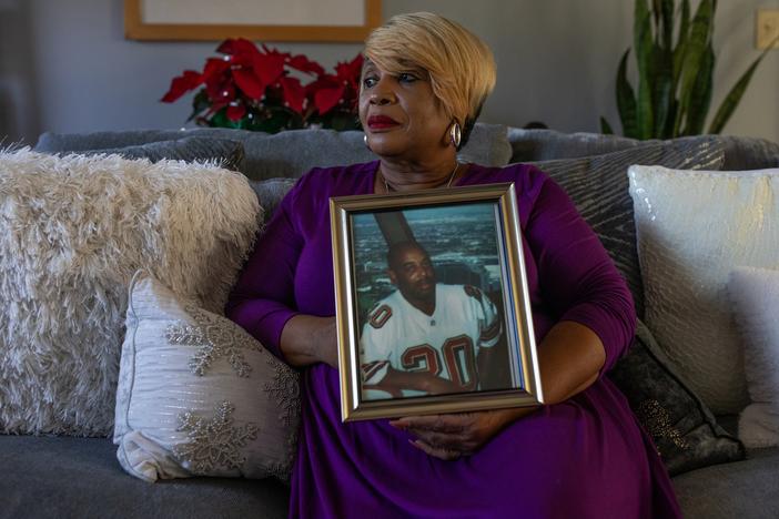 Melinda Mattocks-Ushry holds a photo of her brother Kelvin “Chuck” Mattocks at her home in New Bern, N.C., on Dec. 5, 2023. 