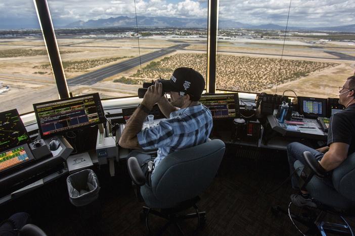 Air traffic controllers watch for traffic from the control tower at the Tucson International Airport on Sept. 23, 2016 in Tucson, Ariz.