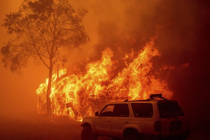 Flames consume a building as the Park Fire tears through the Cohasset community in Butte County, Calif., on Thursday.