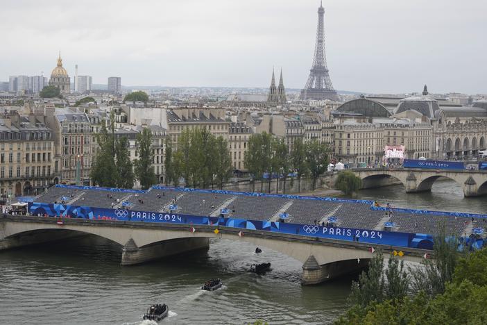 Police boats patrol the Seine river in Paris ahead of the opening ceremony of the 2024 Summer Olympics, Friday.