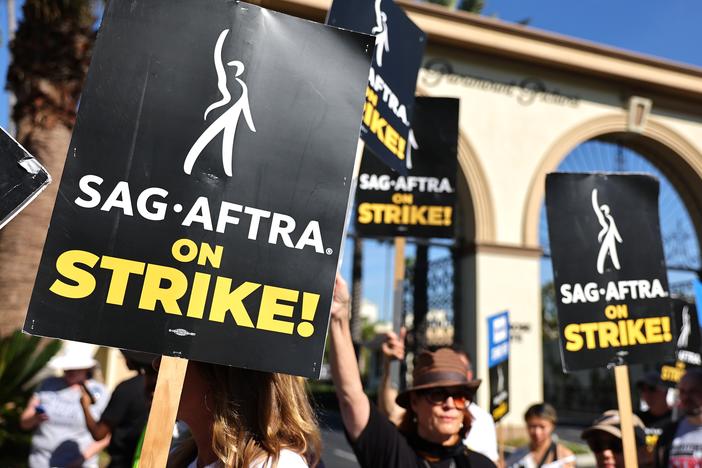 SAG-AFTRA members picket outside Paramount Studios in 2023. Members of the union were on strike between July and November during negotiations with Hollywood film and television studios. Now, the focus is on video games. 