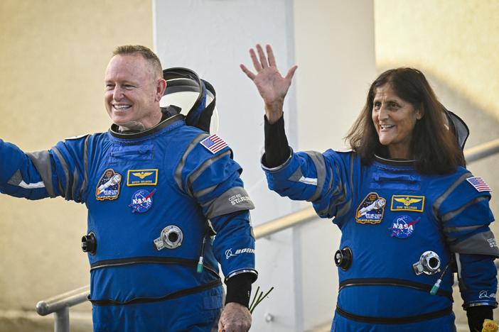NASA astronauts Butch Wilmore (L) and Suni Williams, wave as they prepare to depart the Neil A. Armstrong Operations and Checkout Building at Cape Canaveral Space Force Station in Florida to board the Boeing CST-100 Starliner spacecraft, on June 5, 2024. 