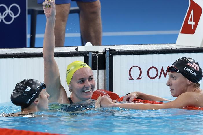 Ariarne Titmus of Team Australia celebrates after winning gold as Canada's Summer McIntosh (left) and USA's Katie Ledecky (right) win silver and bronze in the Women's 400m Freestyle Final on Saturday at Paris La Defense Arena in Nanterre, France.