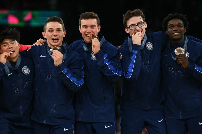 Members of the U.S. men's gymnastics team pose with their bronze medal following the men's team final on Monday. It's the first Olympic medal for the U.S. in the event since 2008.