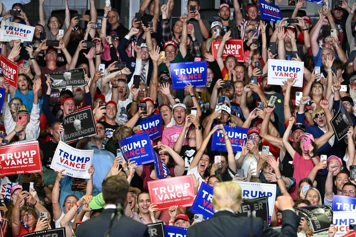 The crowd cheers as former President Donald Trump, right bottom, and Sen. JD Vance attend their first campaign rally together in Grand Rapids, Mich., on July 20.