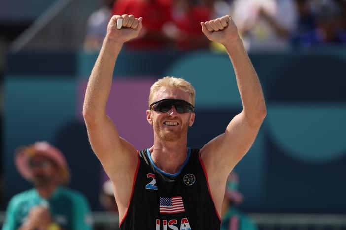 Chase Budinger celebrates after his team defeated a French duo during the Men's Preliminary Phase - Pool F match on Monday.