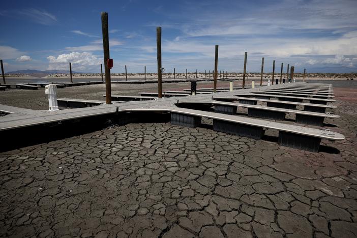 Boat docks sit on dry cracked earth at the Great Salt Lake's Antelope Island Marina in 2021 near Syracuse, Utah.