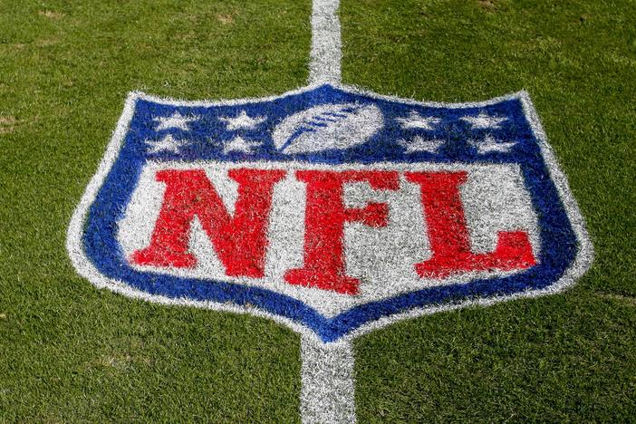 The NFL logo is displayed on the field in Charlotte, N.C., on Nov. 4, 2018.  The judge who presided in a class-action lawsuit filed by “Sunday Ticket” subscribers against the NFL said Thursday that the jury did not follow his instructions in determining damages.