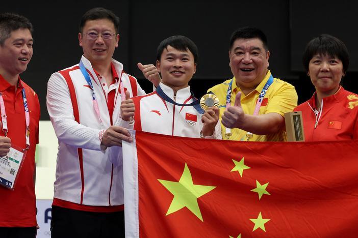 Gold medalist China's Xie Yu poses with team members at the end of the shooting 10m air pistol men's final during the Paris 2024 Olympic Games at Chateauroux Shooting Center. Chinese shooters have accounted for four of China's 13 gold medals.