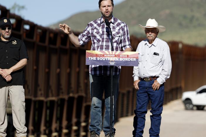 Republican vice presidential nominee Sen. JD Vance of Ohio delivers remarks alongside rancher John Ladd (right) and Paul A. Perez, president of the National Border Patrol Council, as Vance tours the U.S. Border Wall on Thursday in Montezuma Pass, Ariz. Vance is visiting the border on the final stop of his first visit to the Southwest as a vice presidential candidate. 