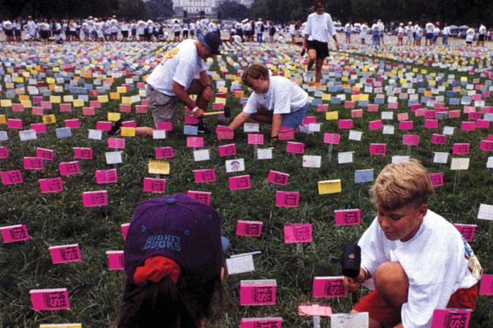 In 1994, young people wearing "True Love Waits" T-shirts hammer pledge cards stating they'll abstain from sex until marriage into the lawn of the National Mall in Washington, D.C.
